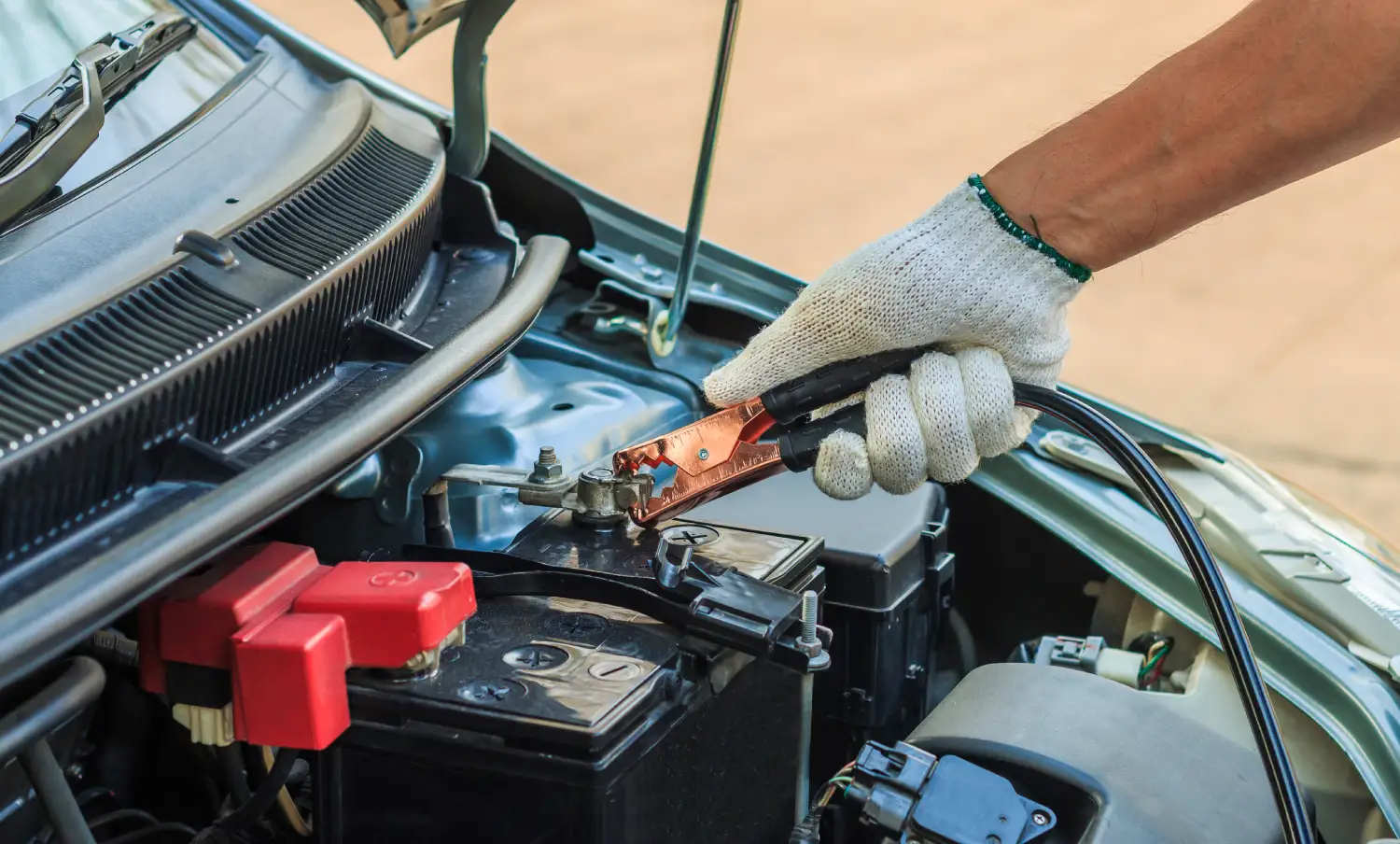 12v PitStop technician performing a car jump start in East of Kailash, South Delhi